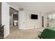 Bright bedroom with carpet, a ceiling fan, a TV, and a view to other rooms at 10653 E Lindner Cir, Mesa, AZ 85209