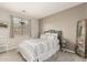 Cozy bedroom with a queen bed, natural lighting, and light grey walls at 10653 E Lindner Cir, Mesa, AZ 85209