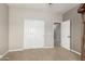 Empty bedroom with neutral walls and carpet, with an open door to the bathroom at 10653 E Lindner Cir, Mesa, AZ 85209