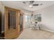 Bright bedroom with a ceiling fan, a desk, and a wood sauna in the corner at 10653 E Lindner Cir, Mesa, AZ 85209