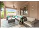 Inviting covered patio featuring ample seating and stylish decor at 10653 E Lindner Cir, Mesa, AZ 85209