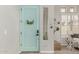 Stylish entryway with a vibrant mint door and neutral decor at 10653 E Lindner Cir, Mesa, AZ 85209