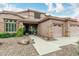 Inviting single-Gathering home featuring a tile roof, neutral stucco exterior, and a charming front porch at 10653 E Lindner Cir, Mesa, AZ 85209