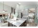 Open-concept kitchen with large island, stainless steel appliances and a view to the dining area at 10653 E Lindner Cir, Mesa, AZ 85209