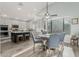 Open concept kitchen and dining area with tile floors, island with stools, and stainless steel appliances at 10653 E Lindner Cir, Mesa, AZ 85209