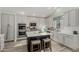 Bright kitchen featuring a center island with seating, stainless steel appliances, and ample cabinet space at 10653 E Lindner Cir, Mesa, AZ 85209