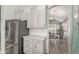Kitchen area featuring subway tile backsplash, white cabinets, and stainless steel refrigerator at 10653 E Lindner Cir, Mesa, AZ 85209