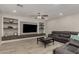 Living room has built-in shelves, a ceiling fan, and wood-look tile flooring at 10653 E Lindner Cir, Mesa, AZ 85209