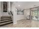 Open living space featuring wood-look tile floors and staircase at 10653 E Lindner Cir, Mesa, AZ 85209