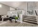 Stylish living area featuring a piano, staircase, and views to the dining room at 10653 E Lindner Cir, Mesa, AZ 85209