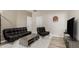 Relaxing living room with leather furniture and a dart board mounted on the wall at 10653 E Lindner Cir, Mesa, AZ 85209