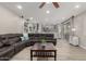 Spacious living room featuring a sectional sofa, wood-look tile flooring, and sliding glass doors at 10653 E Lindner Cir, Mesa, AZ 85209