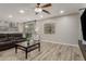 Open living room has recessed lights, wood-look tile, and a sliding glass door to the backyard at 10653 E Lindner Cir, Mesa, AZ 85209