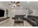 This living room includes wood-look tile, recessed lighting and a ceiling fan at 10653 E Lindner Cir, Mesa, AZ 85209