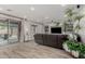 Living room featuring built-in shelving and glass sliding doors to an outdoor patio at 10653 E Lindner Cir, Mesa, AZ 85209