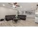 Spacious living room featuring a sectional sofa and wood-look tile flooring at 10653 E Lindner Cir, Mesa, AZ 85209