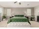 Cozy main bedroom features a ceiling fan, an upholstered headboard, side tables, and a tufted ottoman at 10653 E Lindner Cir, Mesa, AZ 85209