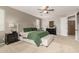 Comfortable main bedroom features a tufted ottoman, two side tables, and an ensuite bathroom at 10653 E Lindner Cir, Mesa, AZ 85209