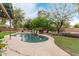 Tranquil backyard swimming pool with a rock waterfall feature at 10653 E Lindner Cir, Mesa, AZ 85209