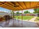 Inviting back patio area with comfortable seating, grill, and view of the spacious, well-maintained backyard at 1143 E 7Th St, Mesa, AZ 85203