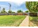 Expansive backyard featuring a well-kept lawn, mature trees, and a charming walkway at 1143 E 7Th St, Mesa, AZ 85203
