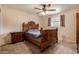 A bedroom with a wooden bed frame, ceiling fan, and a window allowing natural light at 1143 E 7Th St, Mesa, AZ 85203