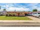 Charming brick home featuring a lush lawn, long driveway, and a covered parking area for your vehicles at 1143 E 7Th St, Mesa, AZ 85203