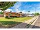 Charming brick home featuring a lush lawn, long driveway, and a covered parking area for your vehicles at 1143 E 7Th St, Mesa, AZ 85203