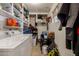 A well-stocked laundry area with shelving, washer, and dryer for easy cleaning and storage solutions at 1143 E 7Th St, Mesa, AZ 85203
