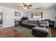 Cozy living room with hardwood floors, a comfortable gray sectional, and a ceiling fan at 1143 E 7Th St, Mesa, AZ 85203