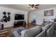 Cozy living room with hardwood floors, a comfortable gray sectional, and a ceiling fan at 1143 E 7Th St, Mesa, AZ 85203