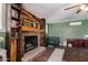 Living room featuring a stone fireplace with decorative wood paneling and built-in shelving at 1143 E 7Th St, Mesa, AZ 85203