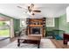 Living room with a wood-burning fireplace, ceiling fan, and sliding doors at 1143 E 7Th St, Mesa, AZ 85203