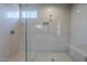 Modern bathroom featuring a glass-enclosed shower, built-in bench, and neutral tile at 11996 N Luckenbach St, Surprise, AZ 85388