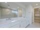 Main bathroom featuring double sinks, a large shower, and a walk-in closet at 11996 N Luckenbach St, Surprise, AZ 85388