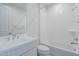 White bathroom with tub and shower combo, and vanity with ample counter space at 11996 N Luckenbach St, Surprise, AZ 85388