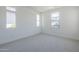 Empty bedroom with white walls, neutral carpet, and multiple windows at 11996 N Luckenbach St, Surprise, AZ 85388