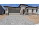 Beautiful, modern home featuring a two-car garage and stone accents at 11996 N Luckenbach St, Surprise, AZ 85388