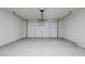 Clean, empty garage with a white door and sealed concrete floors at 11996 N Luckenbach St, Surprise, AZ 85388