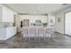 Bright, modern kitchen with white cabinetry, island with seating, and stainless steel appliances at 11996 N Luckenbach St, Surprise, AZ 85388