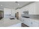 Bright kitchen featuring white cabinetry, stainless appliances, and a large island at 11996 N Luckenbach St, Surprise, AZ 85388