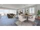 Open-concept living room with large windows, dining area, and stylish decor, creating a welcoming space at 11996 N Luckenbach St, Surprise, AZ 85388
