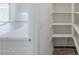 Walk-in pantry with ample shelving and nearby kitchen with white cabinets at 11996 N Luckenbach St, Surprise, AZ 85388