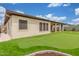 Backyard putting green with lush artificial grass, surrounded by gravel, fence, and turf at 1303 W Cherrywood Dr, Queen Creek, AZ 85140