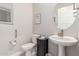 Cozy half-bathroom features neutral walls and decorative fixtures at 1303 W Cherrywood Dr, Queen Creek, AZ 85140