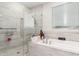 Bathroom featuring a shower, soaking tub, and neutral tiling at 1303 W Cherrywood Dr, Queen Creek, AZ 85140