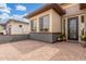 Elegant exterior patio featuring decorative rod iron front door, brick pavers, and low maintenance landscaping at 1303 W Cherrywood Dr, Queen Creek, AZ 85140