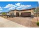 Attractive single story home featuring a brick paver driveway, gated entrance, and a two car garage at 1303 W Cherrywood Dr, Queen Creek, AZ 85140