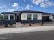 Attractive single Gathering home with stucco facade, low maintenance landscaping, brick paver driveway and walkway at 1303 W Cherrywood Dr, Queen Creek, AZ 85140