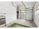 Bright garage with frosted door featuring painted floor, and a tidy space for parking and storage needs at 1303 W Cherrywood Dr, Queen Creek, AZ 85140